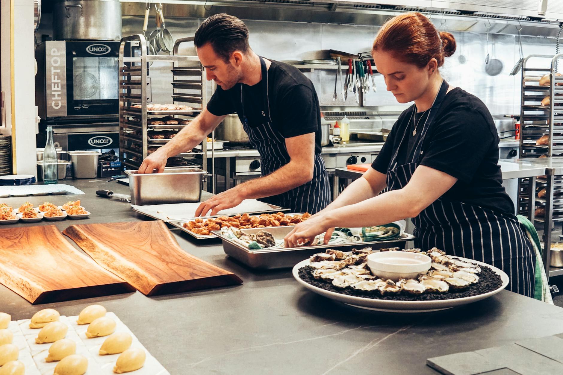 Professional chefs collaborating in a modern commercial kitchen - representing Kitchenly's shared kitchen network